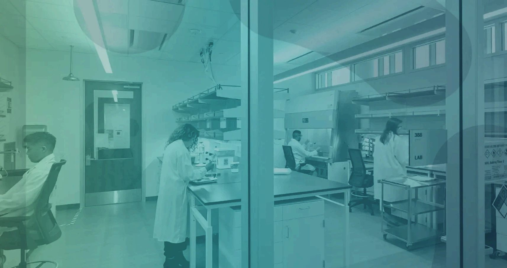 Interior of a research laboratory with cell culture hoods, fume cabinets, and lab benches.